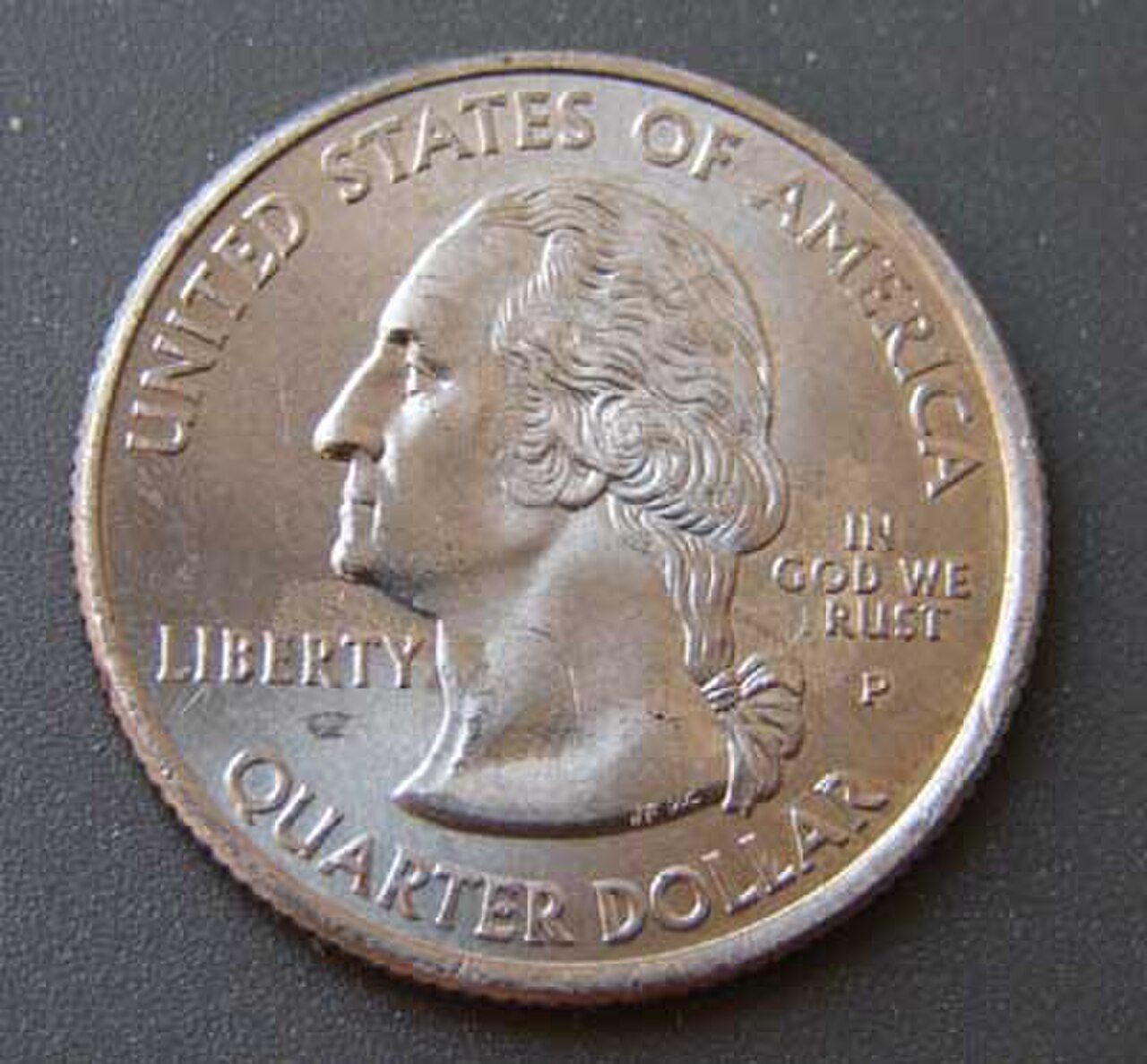 Quarter with the T in TRUST missing because grease filled the die