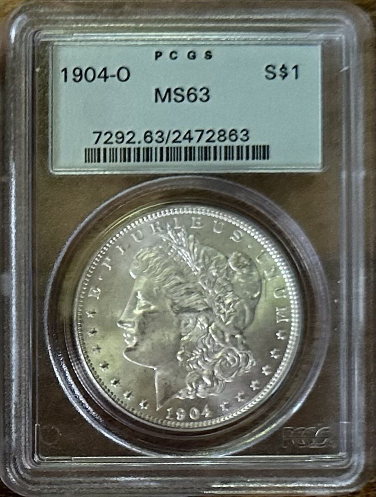 1904-O Morgan dollar certified MS63 by PCGS, sealed in its holder