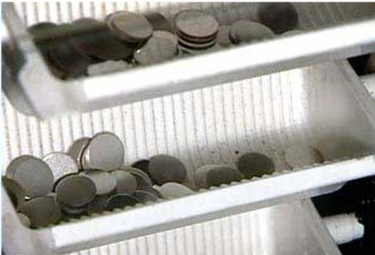 Blank planchets riding the feed system at the United States Mint