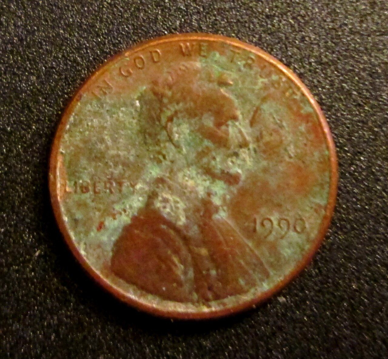 Lincoln cent covered in green verdigris corrosion